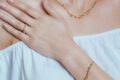 Farah El Khoury Jewelry, image of a woman showcasing golden bracelet and golden necklace