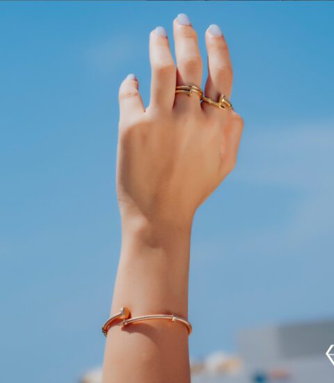 Farah El Khoury Jewelry, image of hand wearing golden ring and golden bracelet