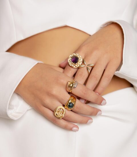 Jewelry Khoury, image of a woman showcasing golden rings