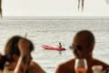 Pierre and Friends, image of a couple sitting on the bar with the Seaview behind them and small kayak