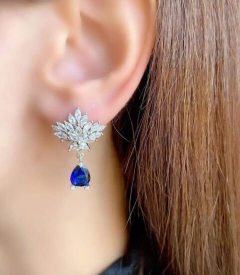 Trois Quart, image of a woman's ear showcasing earrings accessories