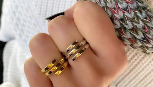 Trois Quart, image of a woman's hand showcasing a ring accessories