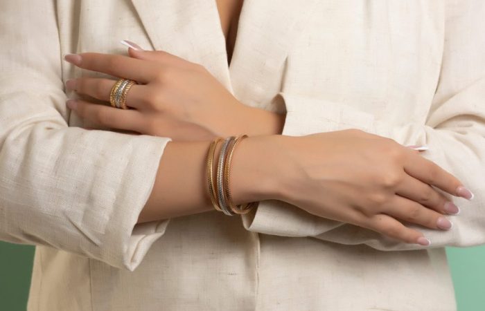 Farah El Khoury Jewelry, image of two hands showcasing golden ring and bracelet
