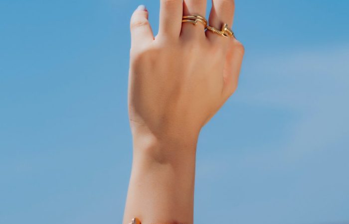 Farah El Khoury Jewelry, image of hand wearing golden ring and golden bracelet