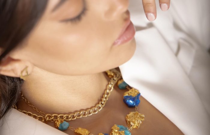 Jewelry Khoury, image of a girl showcasing golden necklace