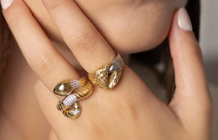 Jewelry Khoury, image of a woman showcasing two golden rings