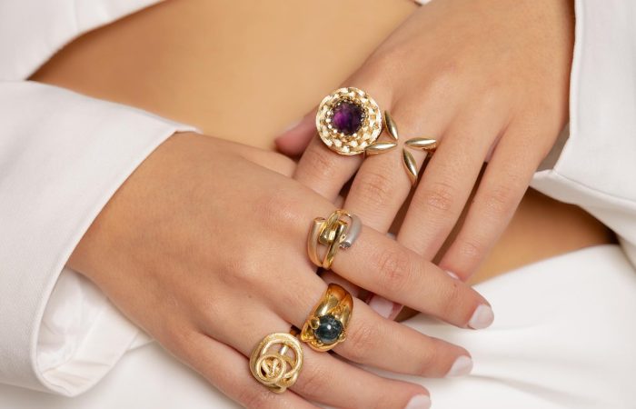 Jewelry Khoury, image of a woman showcasing golden rings