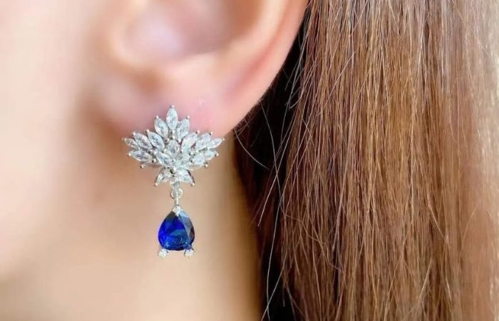 Trois Quart, image of a woman's ear showcasing earrings accessories