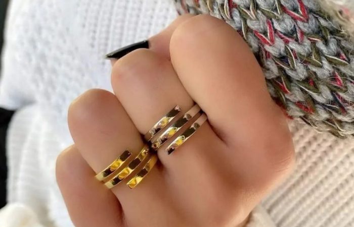 Trois Quart, image of a woman's hand showcasing a ring accessories
